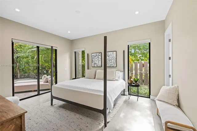 a bedroom with a bed and glass door