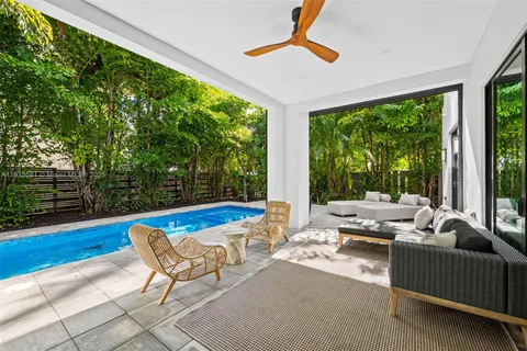 a living room with furniture and a floor to ceiling window