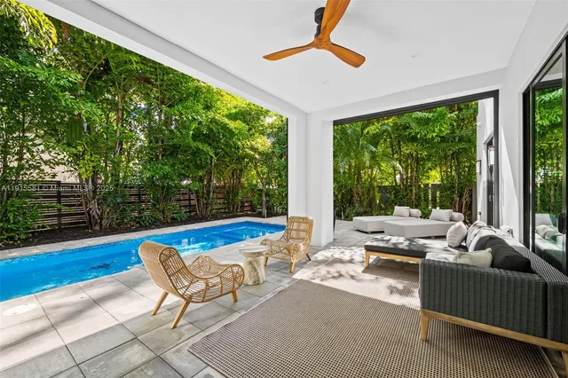 a living room with furniture and a floor to ceiling window