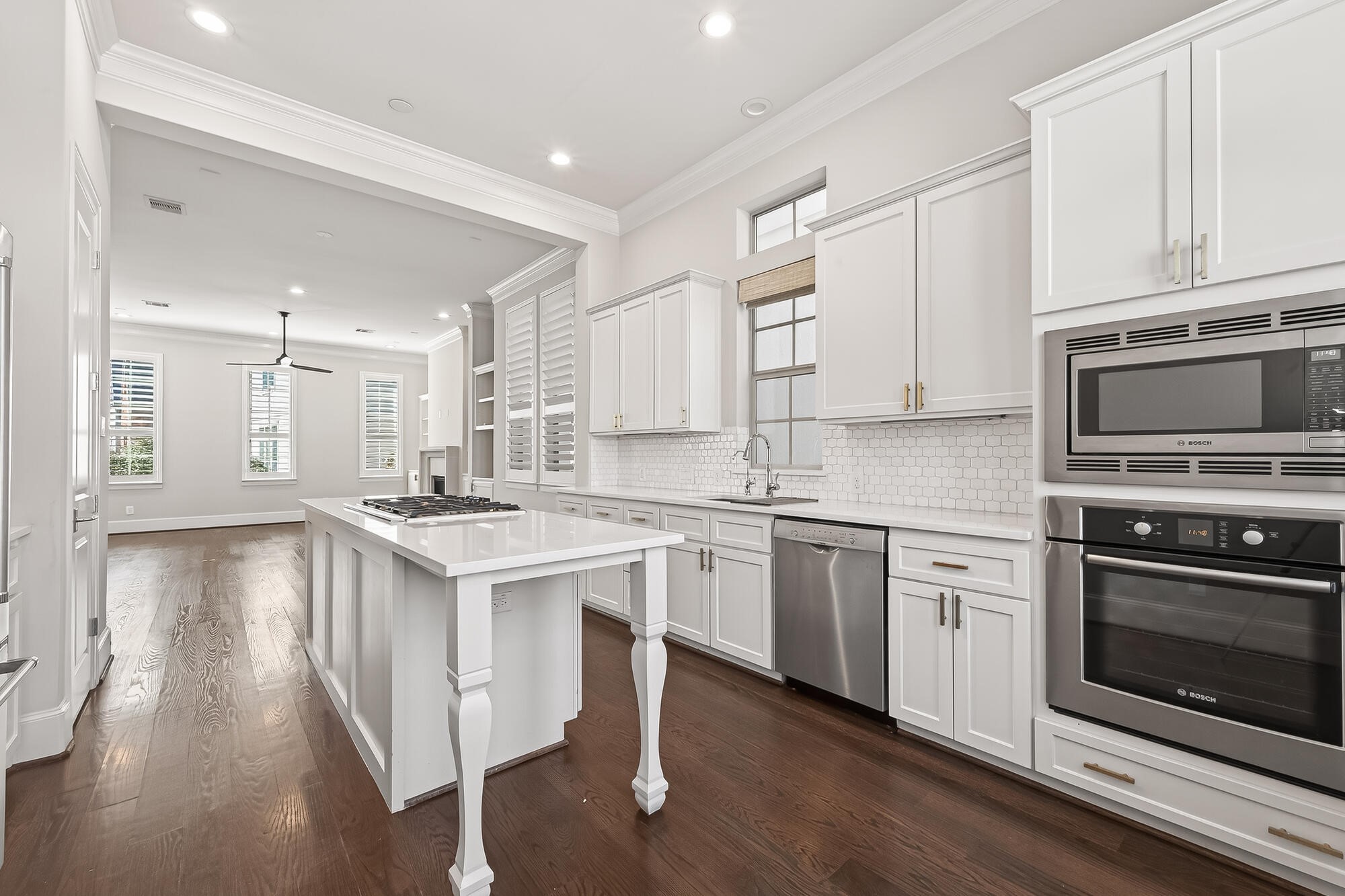 122 Gateway Park Place Spring, TX 77380 - Photo 21 of 44 Remodeled kitchen shines with quartz island, shaker cabinetry, and upgraded wood floors in an open layout.