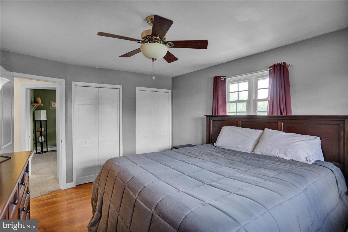 692 Brownsville Road Reading, PA 19608 - Photo 17 of 43 a bedroom with a large bed and a chandelier