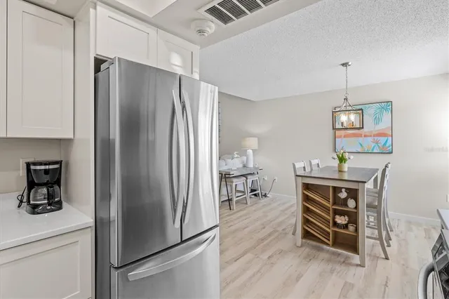 a kitchen with stainless steel appliances a refrigerator and a stove top oven