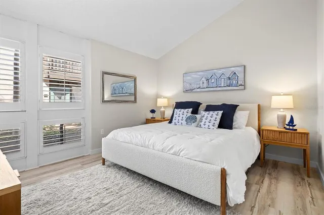 a bedroom with bed and wooden floor