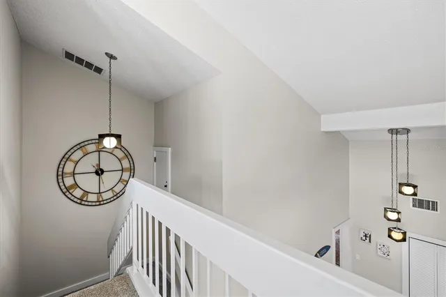 a view of a hallway with mirror on the wall