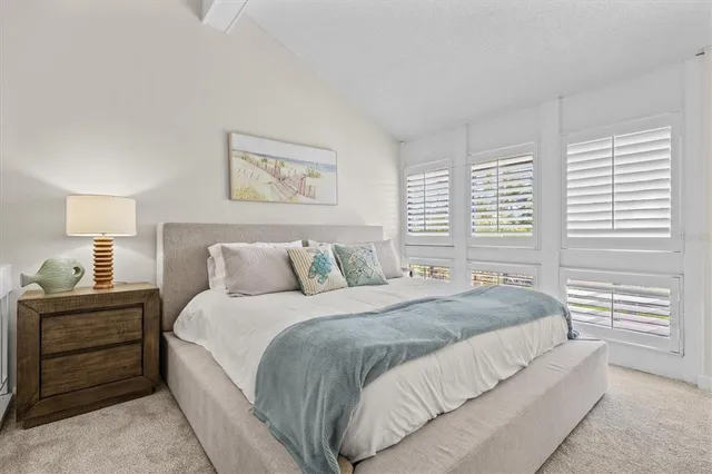 a bedroom with a bed and a night stand