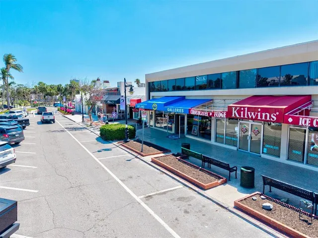 a view of a city with lawn chairs and large trees