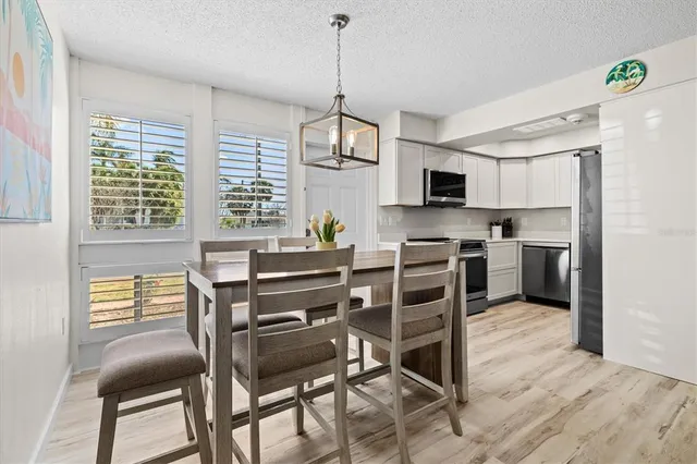 a kitchen with stainless steel appliances a stove a sink island and a refrigerator