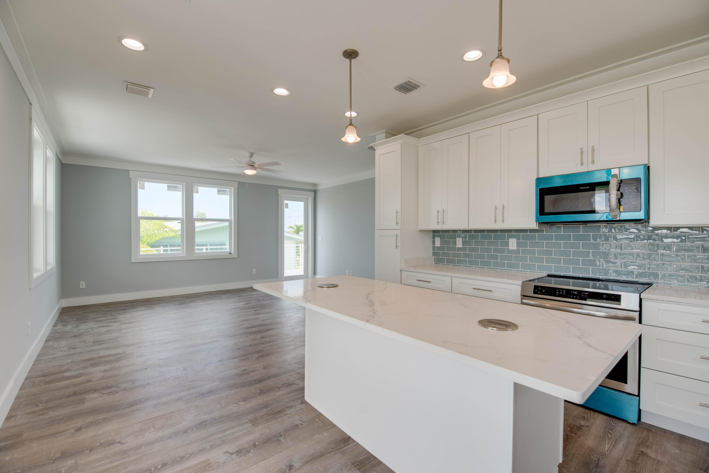 29558 Ranger Avenue Big Pine Key, FL 33043 - Photo 11 of 19 a large kitchen with stainless steel appliances granite countertop a sink a stove a microwave a center island and cabinets