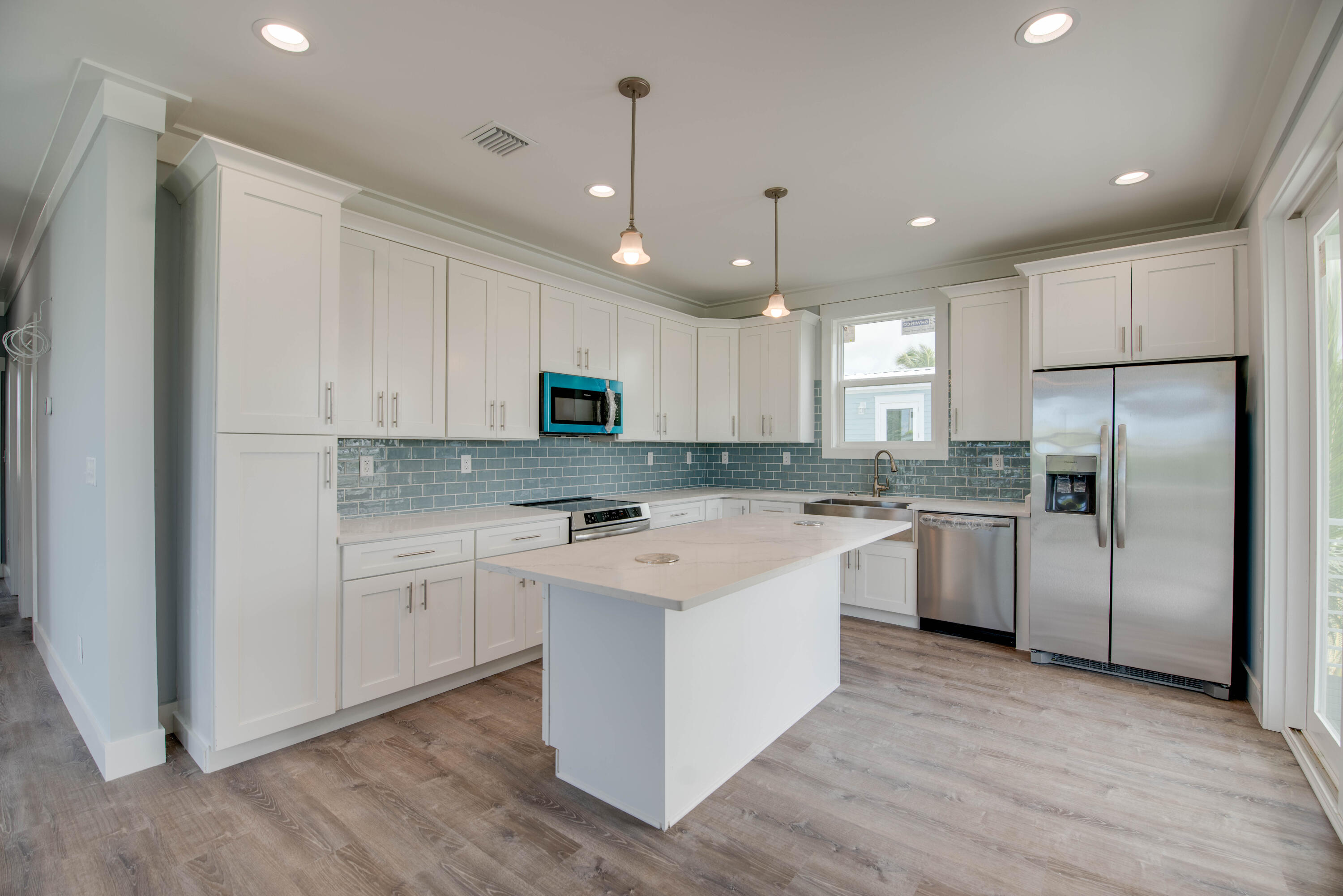 29558 Ranger Avenue Big Pine Key, FL 33043 - Photo 12 of 19 a kitchen with a refrigerator a sink and cabinets