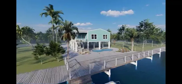 a view of a house with backyard water fountain and sitting area