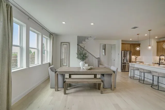 a dining room with furniture and window