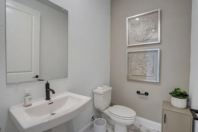 a bedroom with a beds and painting on the wall