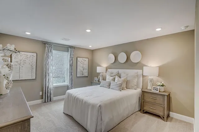 a spacious bedroom with a bed and a large window