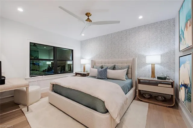 a large bedroom with a bed and a window