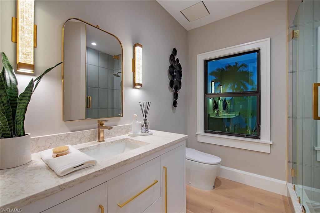655 Parkview Lane Naples, FL 34103 - Photo 29 of 37 a bathroom with a granite countertop sink mirror and toilet