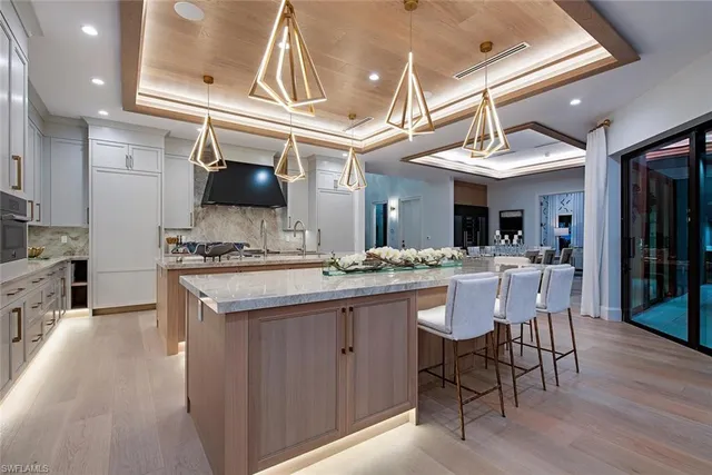 a kitchen with a sink cabinets and wooden floor