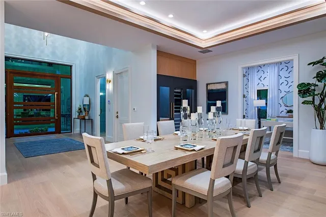 a dining room with a wooden table and chairs