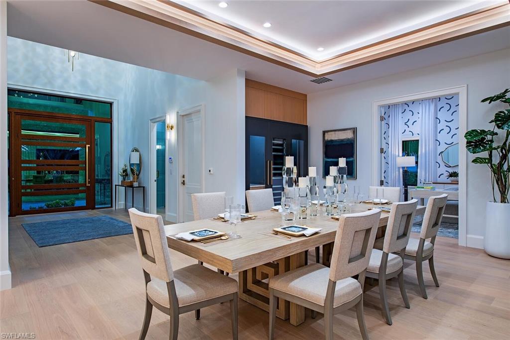 655 Parkview Lane Naples, FL 34103 - Photo 8 of 37 a dining room with a wooden table and chairs