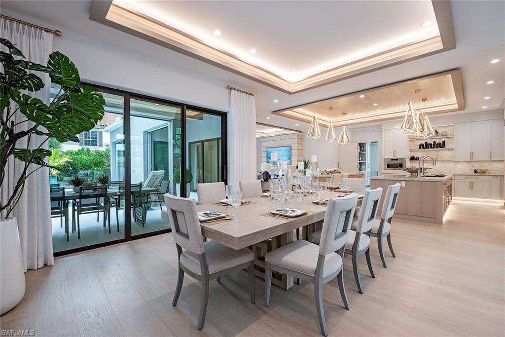 655 Parkview Lane Naples, FL 34103 - Photo 9 of 37 a view of a dining room with furniture window and wooden floor