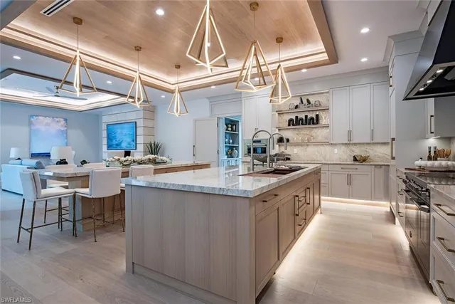 a kitchen with lots of counter top space and painting on the wall