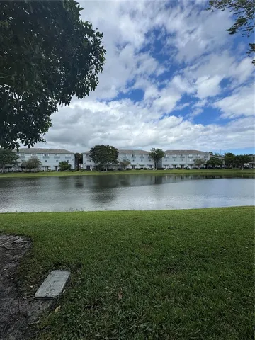 a view of a lake with houses in the back