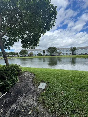 a view of a lake with houses in the back