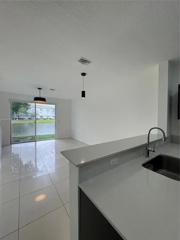 a kitchen with a sink and a stove