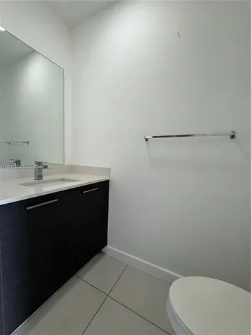 a bathroom with a sink a toilet and vanity