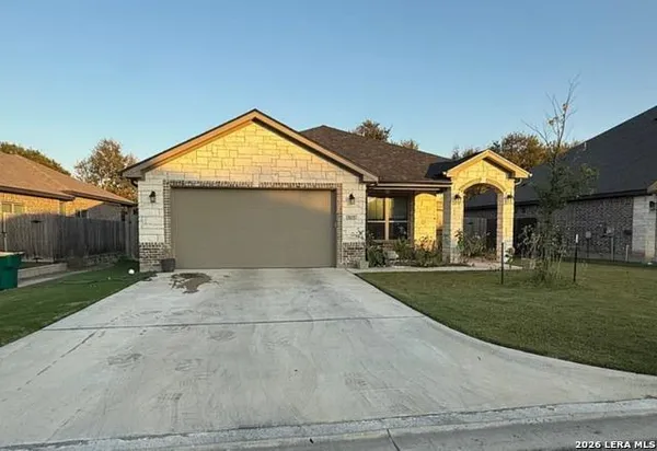 a view of a house with a yard and garage