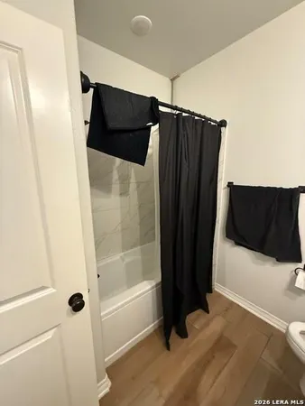 a bathroom with a shower and a tub