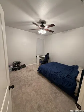 a bedroom with a bed and a ceiling fan