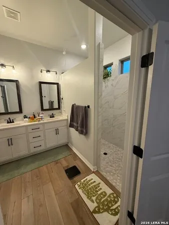 a kitchen with white cabinets and counter space
