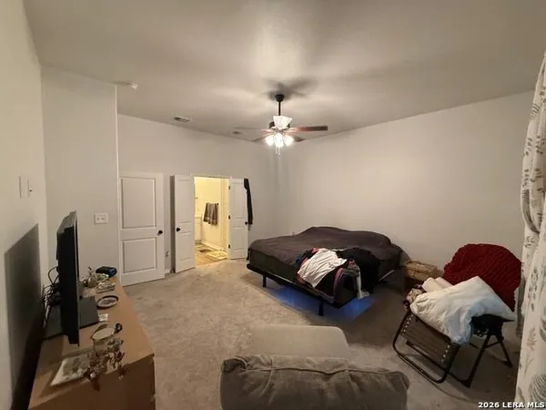 a bedroom with bed and a chandelier