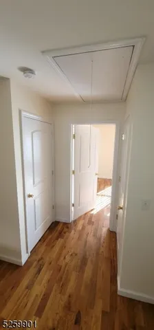 a view of an empty room and wooden floor