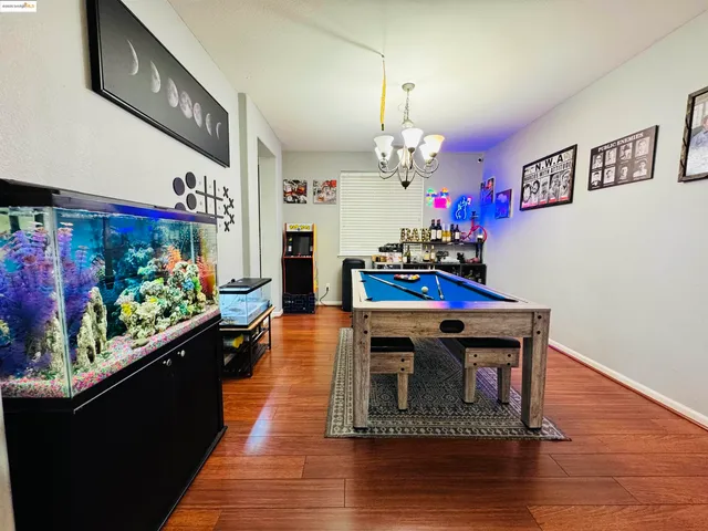 a view of a room with wooden floor and furniture