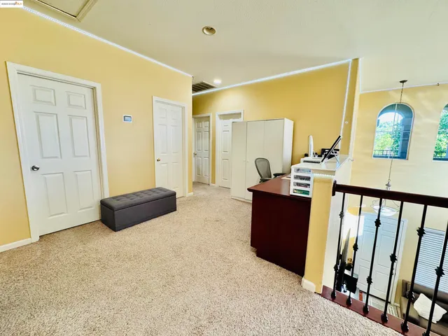 a living room with furniture and a mirror
