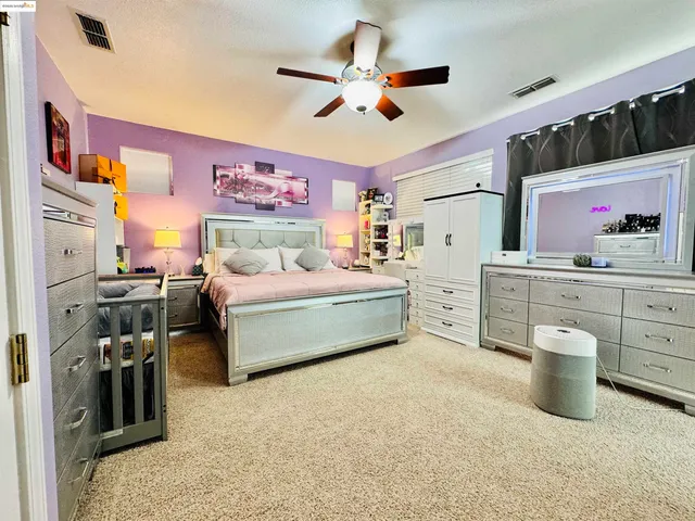 a bedroom with furniture and a chandelier