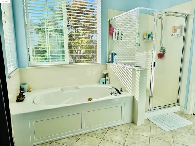 a bathroom with a bathtub and a shower