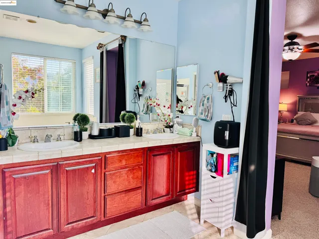 a bathroom with a sink vanity and mirror