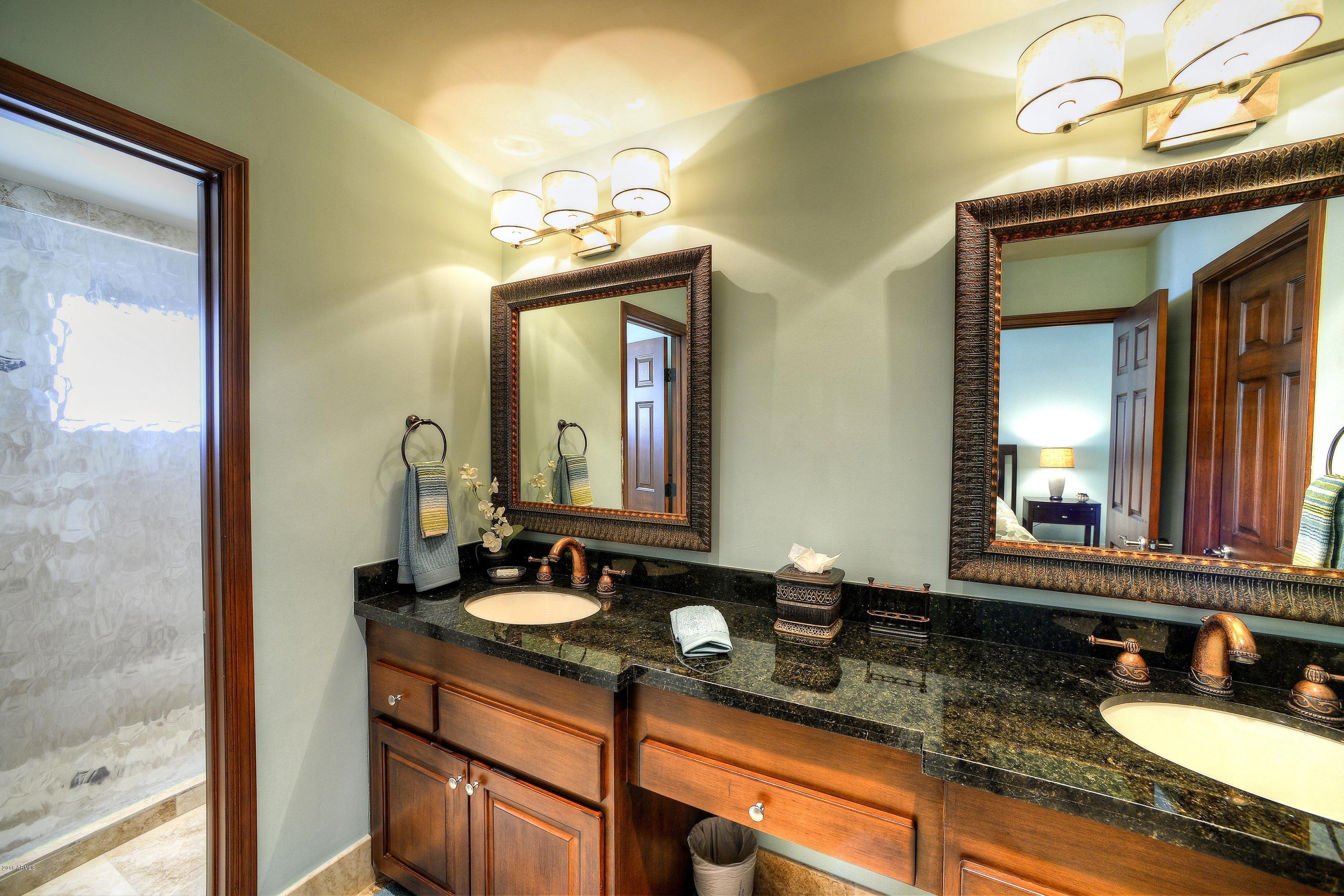 7740 East Gainey Ranch Road, Unit 58 Scottsdale, AZ 85258 - Photo 14 of 27 a bathroom with a granite countertop sink and a mirror