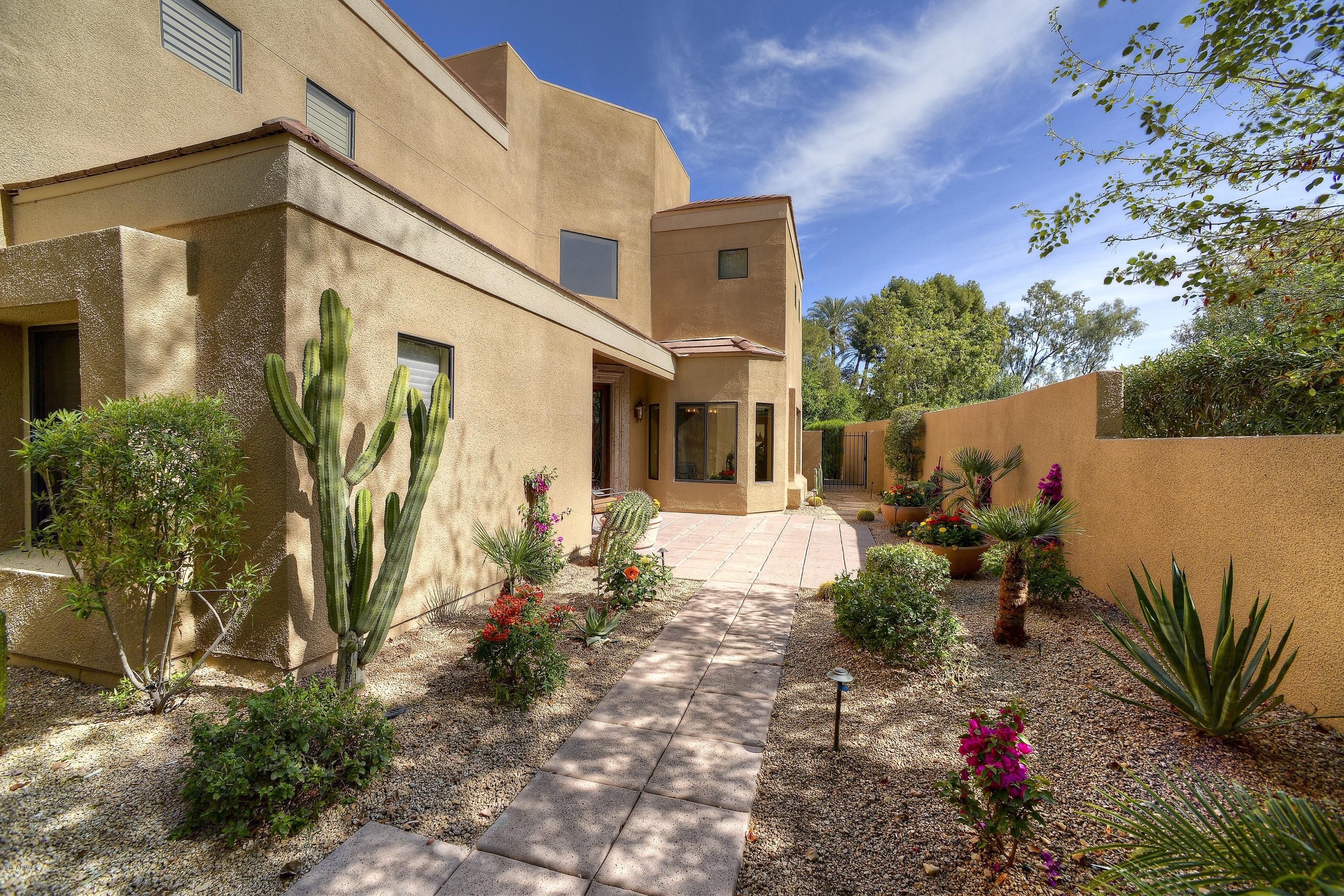 7740 East Gainey Ranch Road, Unit 58 Scottsdale, AZ 85258 - Photo 20 of 27 a front view of a house with a yard