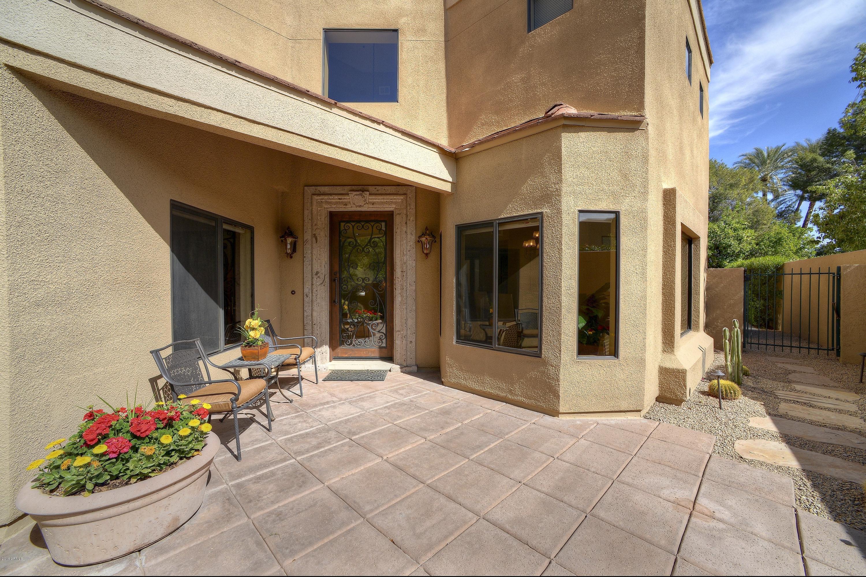 7740 East Gainey Ranch Road, Unit 58 Scottsdale, AZ 85258 - Photo 23 of 27 a lobby with furniture and flowers