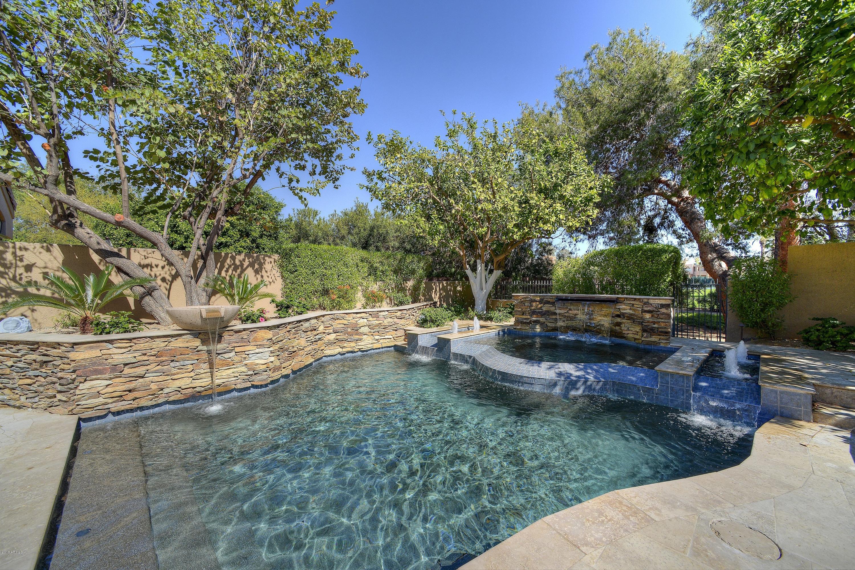 7740 East Gainey Ranch Road, Unit 58 Scottsdale, AZ 85258 - Photo 27 of 27 a view of backyard with swimming pool and sitting area