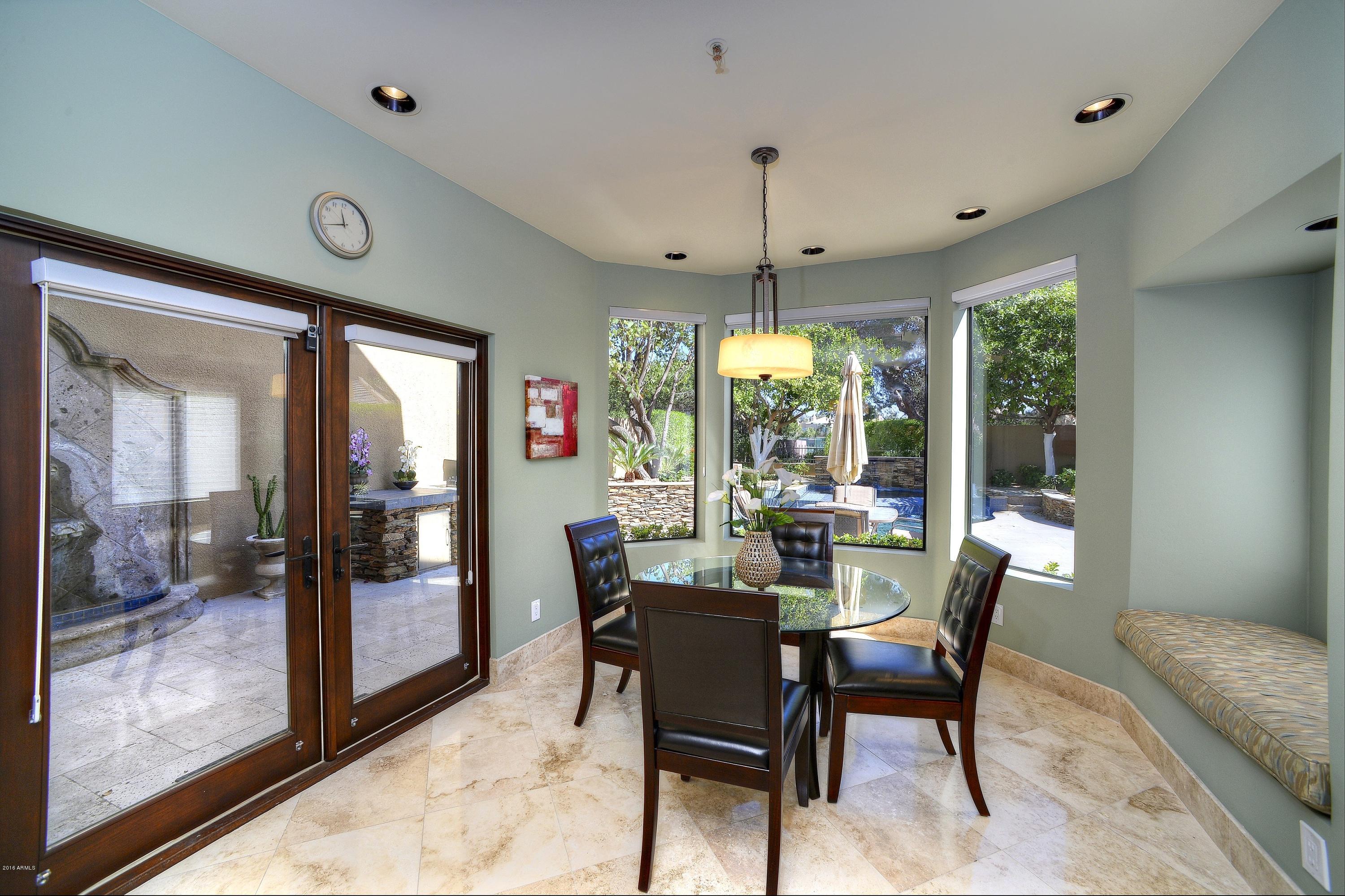 7740 East Gainey Ranch Road, Unit 58 Scottsdale, AZ 85258 - Photo 9 of 27 a view of a dining room with furniture window and outside view