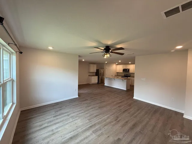 a view of a kitchen with a dishwasher cabinets and wooden floor