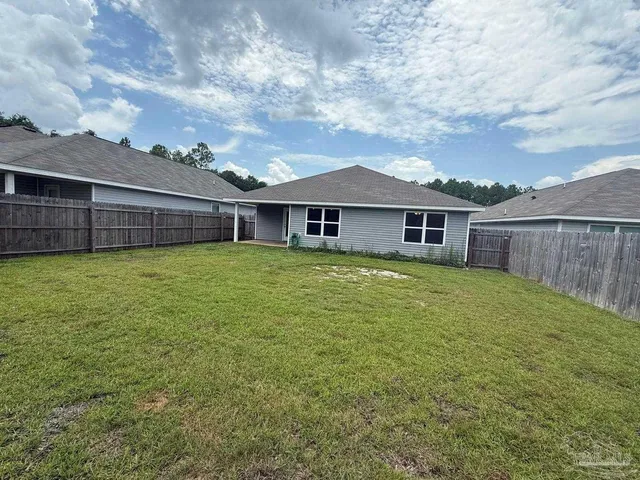 a view of a house with a yard and sitting area