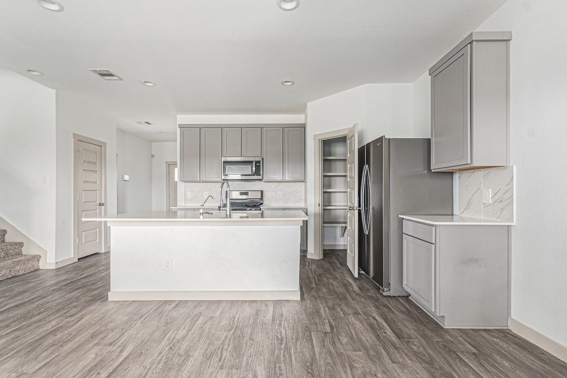 31 Desert Spring Lane Manvel, TX 77578 - Photo 2 of 10 a kitchen with stainless steel appliances a refrigerator sink and cabinets