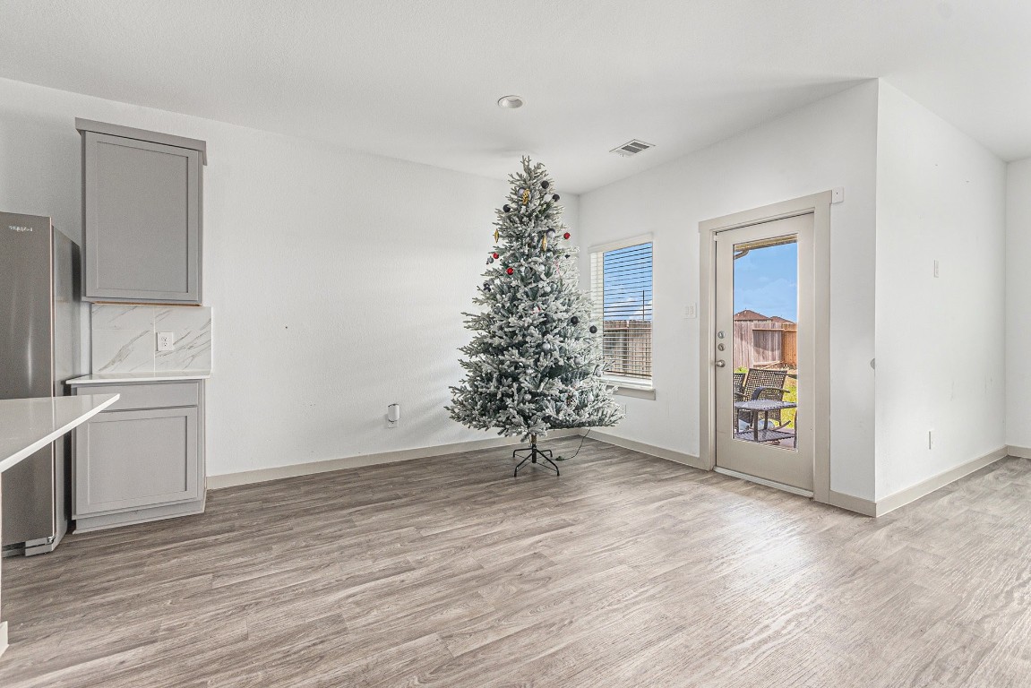 31 Desert Spring Lane Manvel, TX 77578 - Photo 5 of 10 wooden floor in an empty room with a window