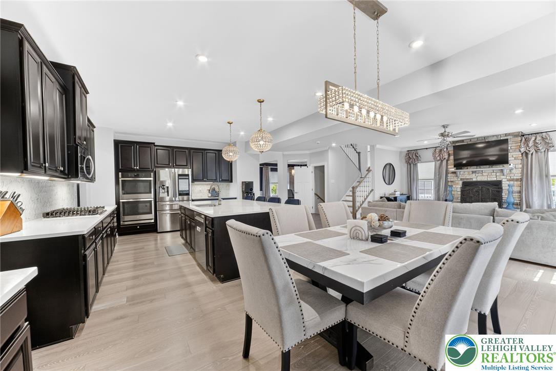 3952 Orth Street Bethlehem, PA 18020 - Photo 3 of 60 An open concept design seamlessly connects the sleek, modern kitchen to a bright dining area and welcoming living space.