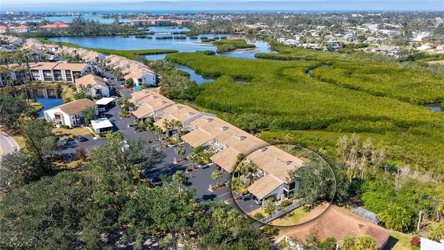 an aerial view of lake and residential houses with outdoor space